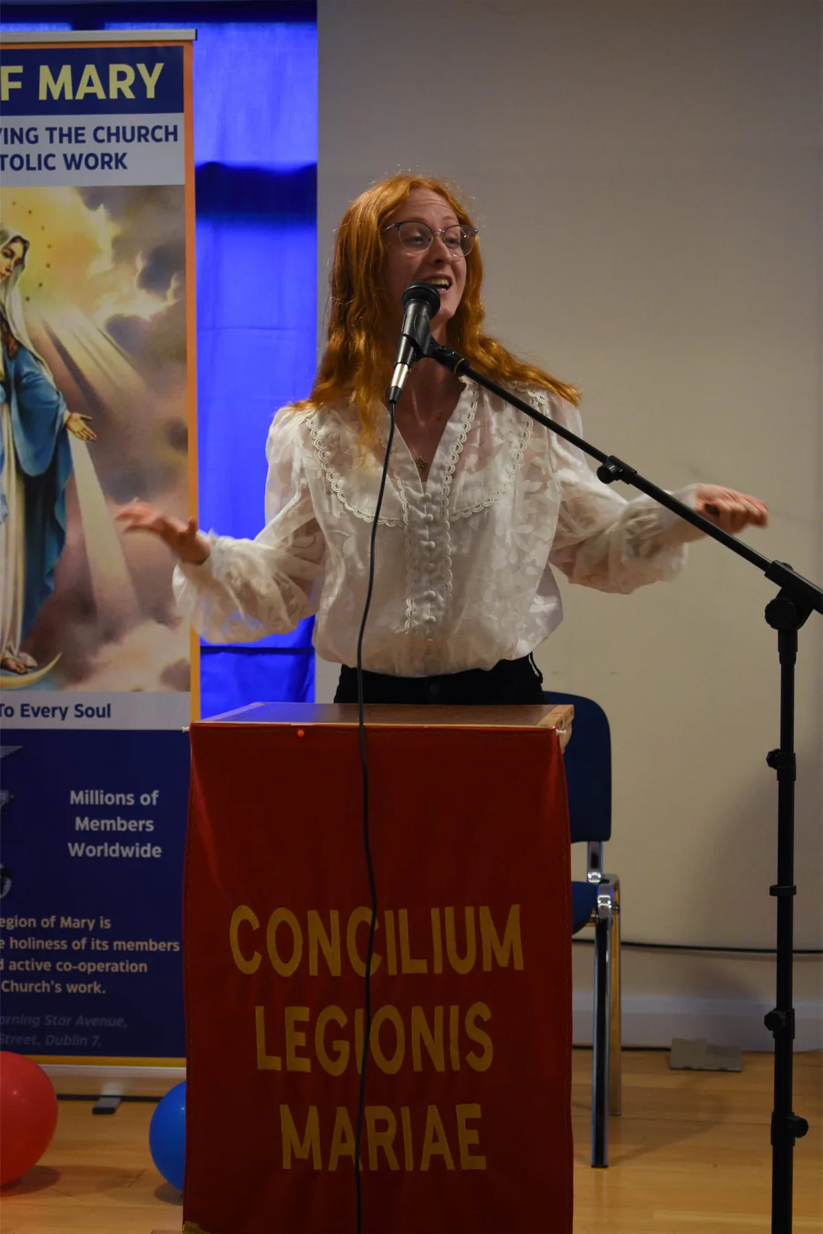 A young legionary giving her testimony to the conference