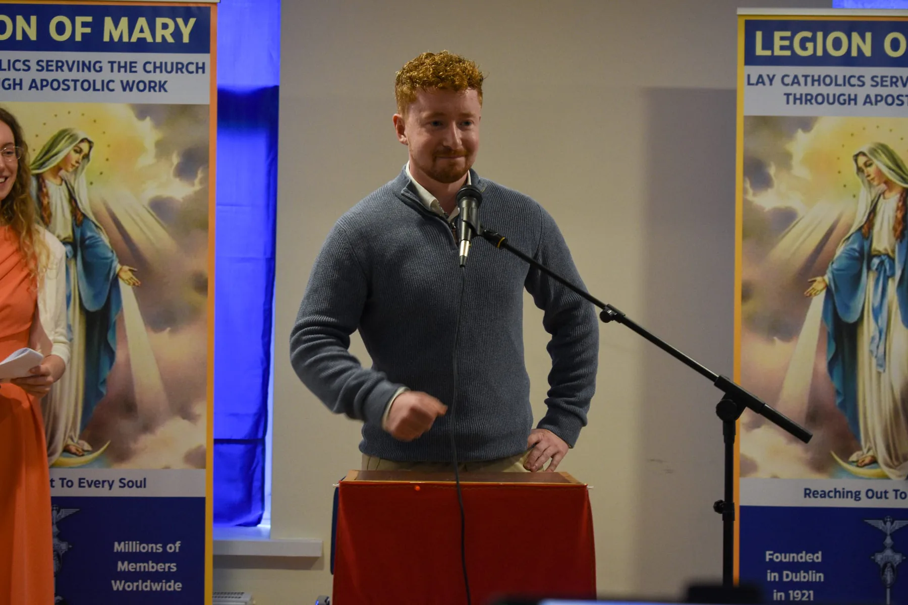 A young adult speaking to the conference from the lectern