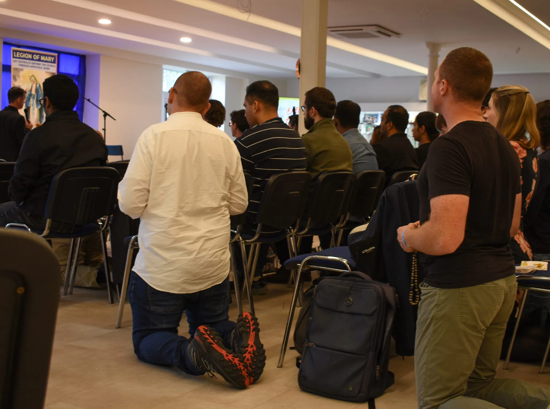 Kneeling for prayer in the conference hall