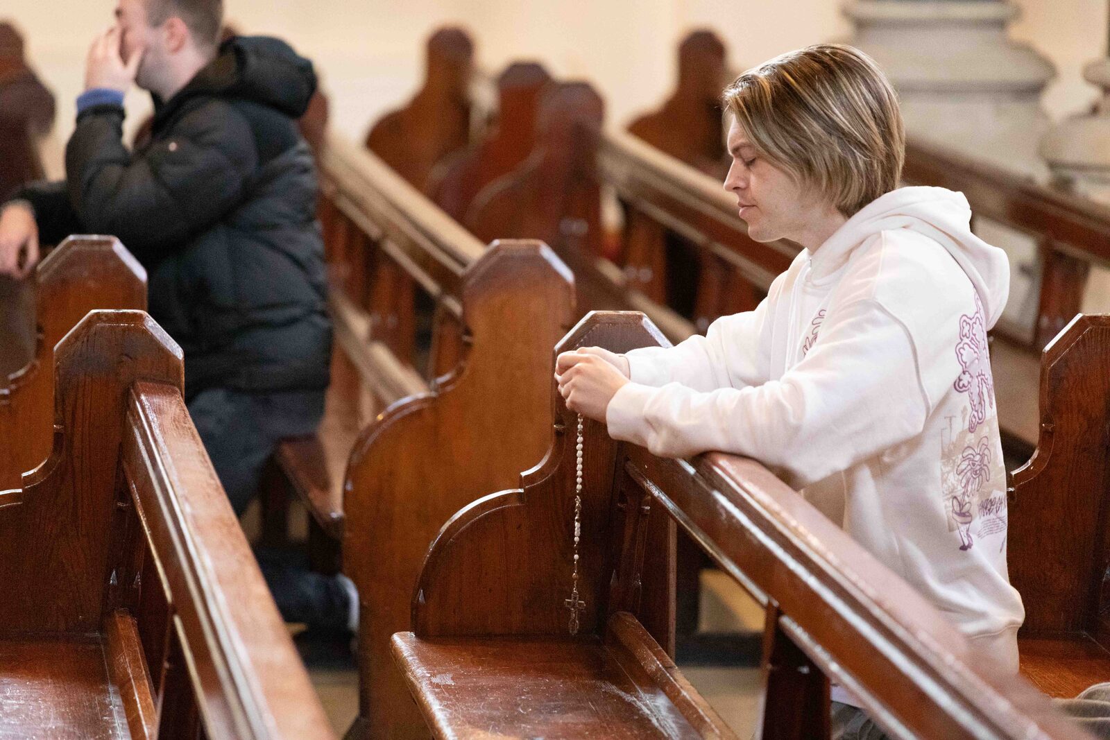 Young woman praying the rosary