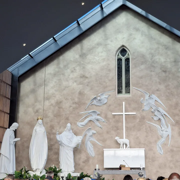 The apparition scene in the Apparition Chapel at Knock: Our Lady, St Joseph and St John the Evangelist, with the Lamb on the altar before the cross