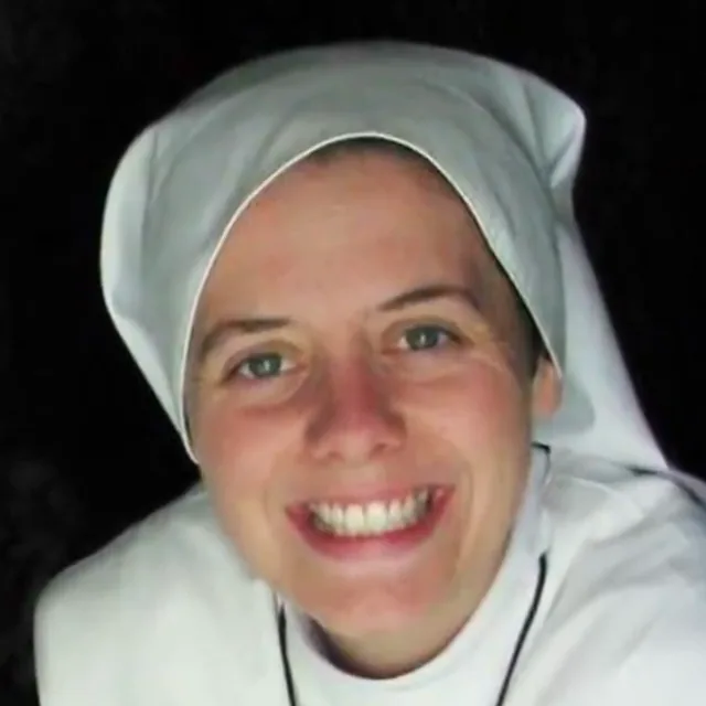 Sr Clare Crockett smiling, in the white habit of the Home of the Mother Sisters.